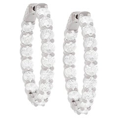 Diana M. 18 kt white gold, 1.00" inside-out hoop earrings adorned with 9.35 cts 