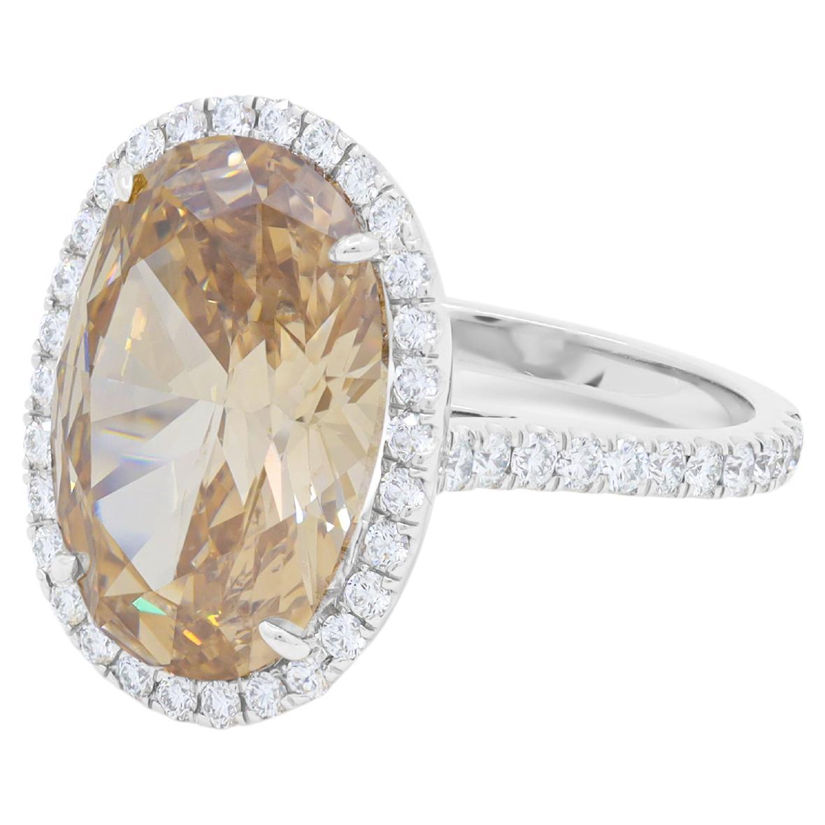 Platinum ring featuring a center 7.91 ct GIA certified fancy conac brown SI clarity  oval cut diamond surrounded by .75 cts tw of diamonds in a halo setting 
Diana M. is a leading supplier of top-quality fine jewelry for over 35 years.
Diana M is