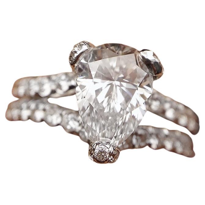 Platinum engagement ring featuring a center 6.71 ct GIA certified (H-VS1) pear shaped diamond surrounded by hidden  micropave diamonds in a split shank setting 2.00CT of diamonds 