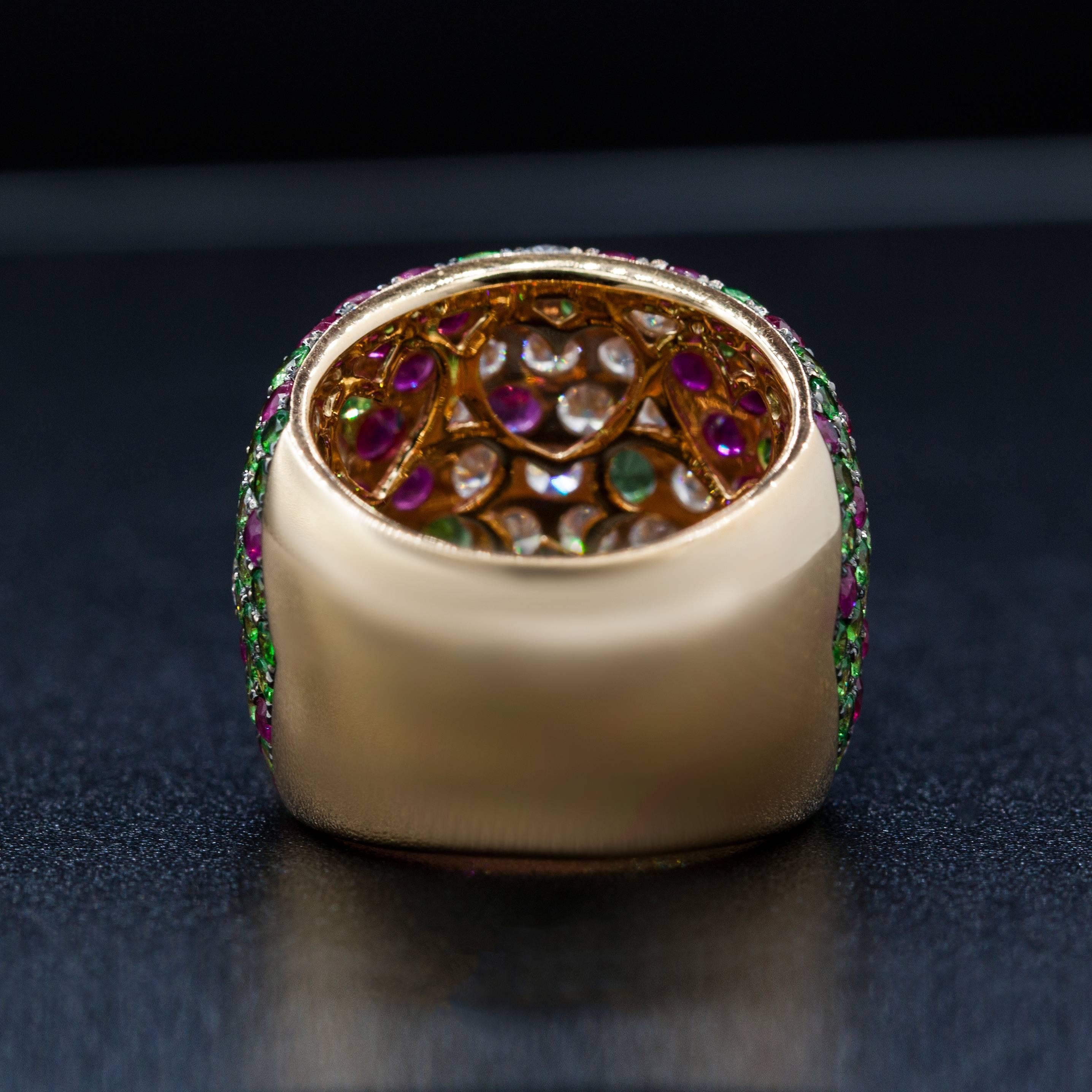 Combination of three colors makes this cigar band absolutely unique. The ring features Tsavorites Rubies and Diamonds, 7.53 carats of rubies and tsavorites all surrounded by 2.50 carats of white diamonds set in 18K Rose Gold. 
