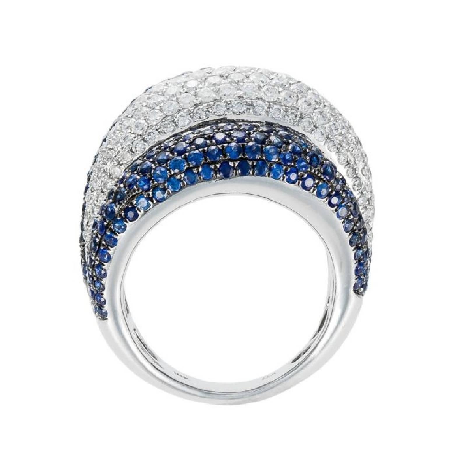 18K White Gold Sapphire and Diamond Dome Ring, features 5.00 carats of blue sapphires with 2.50 carats of diamonds. The diamond color and clarity is G-H SI

