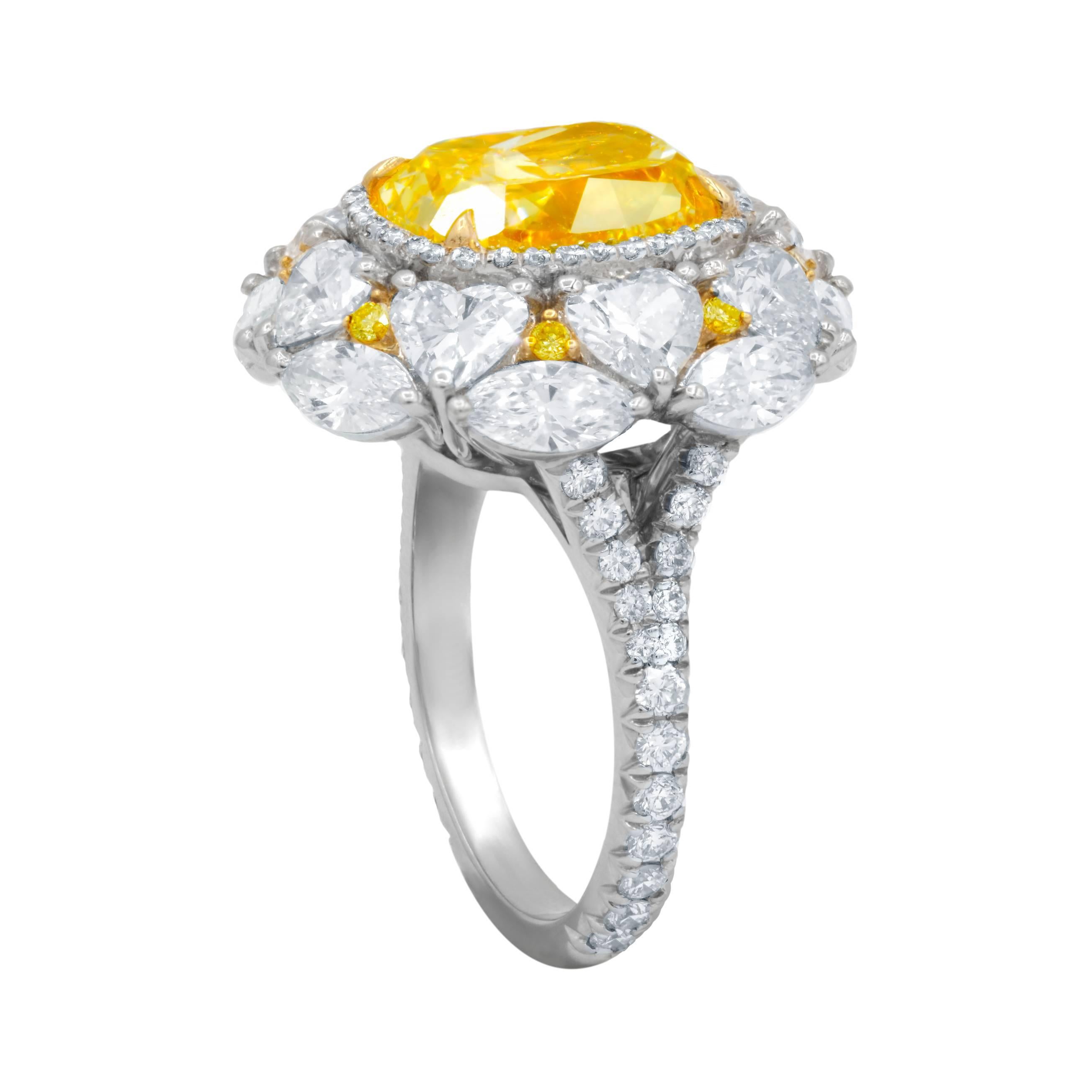 Exclusively designed Fancy Yellow (Canary) Diamond Ring.
The Center Diamond is 5.01 Carat Fancy Light Yellow, VS2 in Clarity, certified by GIA Laboratory, surrounded by 5.00 Carats of diamonds on the side. 8 Heart Shape Diamonds, each approximately