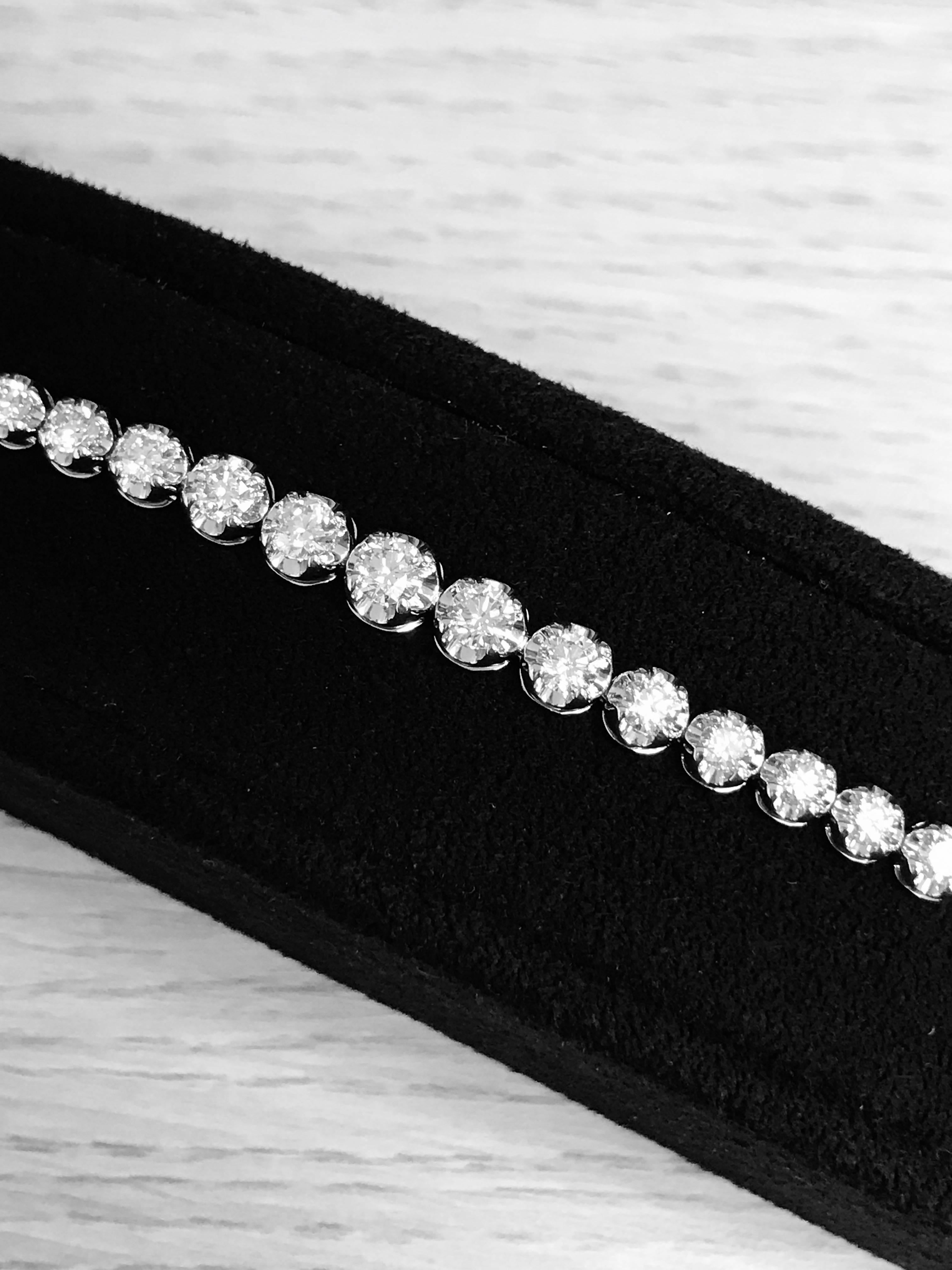 A classic look just for her, this 5 Carat . diamond graduated tennis bracelet is certain to take her breath away. Fashioned in white gold, this eternal design features a brilliant array of sparkling round diamonds arranged so the bigger diamonds are