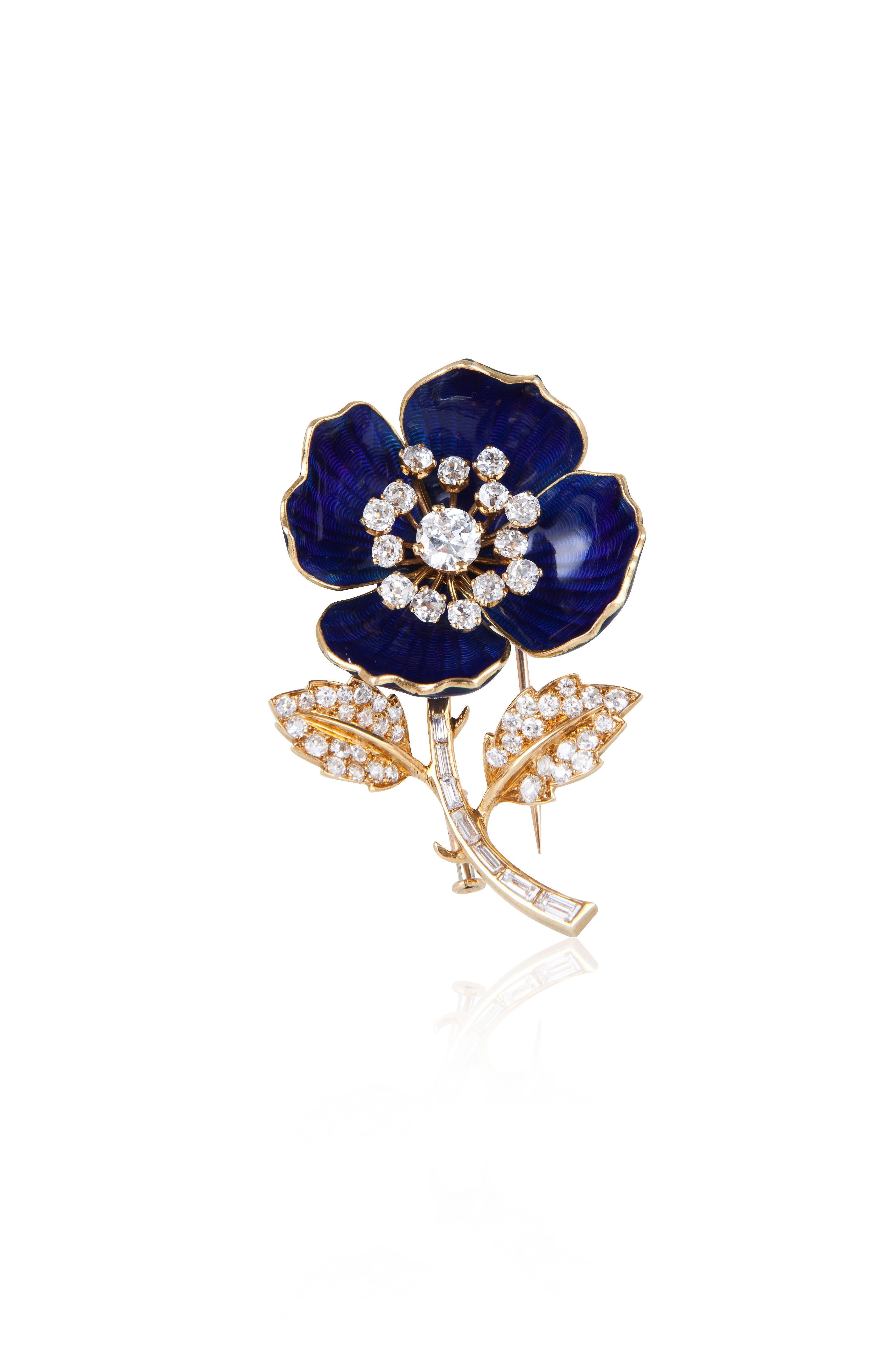 Exceptionally crafted, this pin comes with two separate sets of petals that can be easily swapped depending on one’s mood.  The first exhibits a subtly patterned royal blue enamel, while the second is more glamorous with pavé set diamonds.  The
