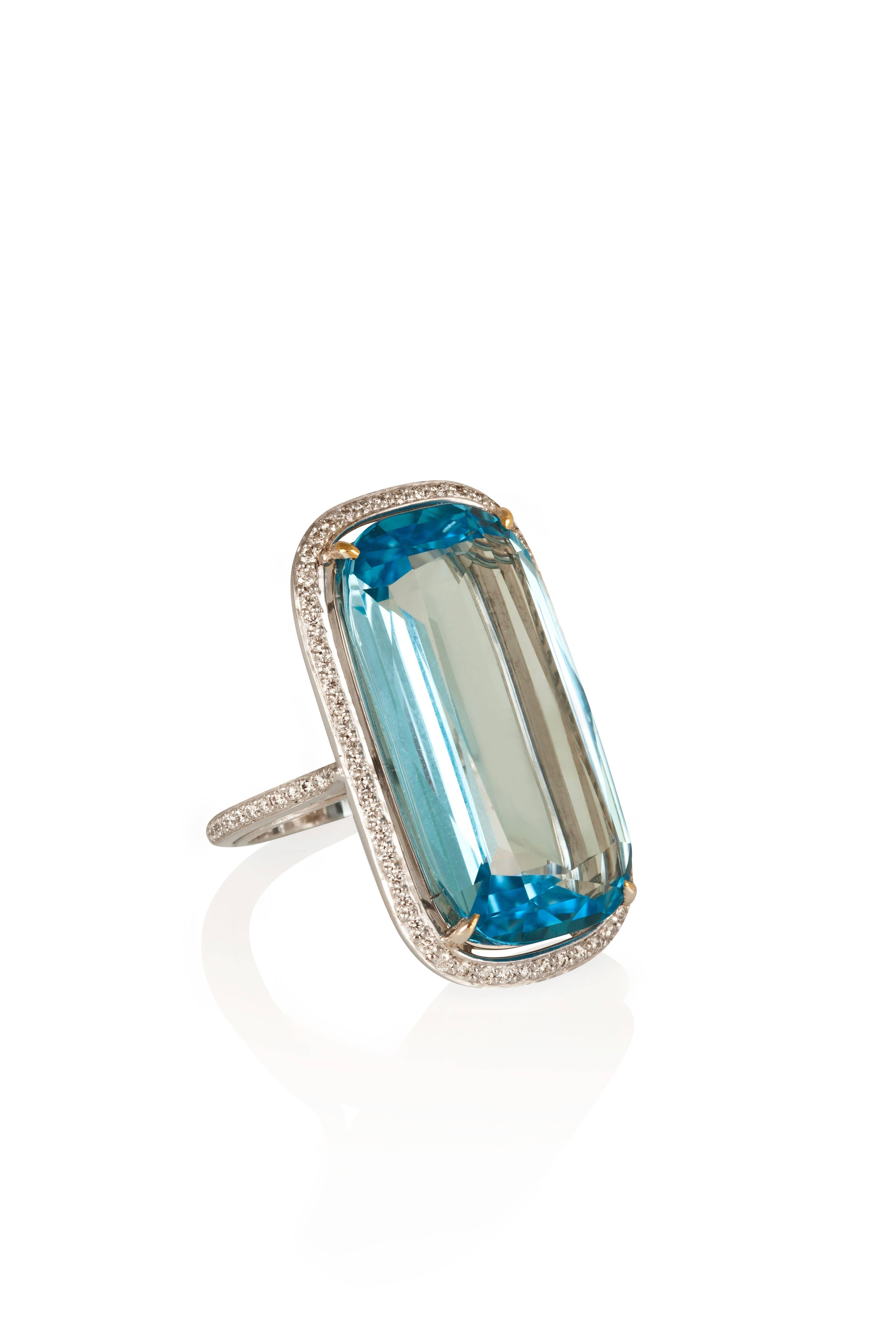 The very definition of “chic,” this ring boasts a gorgeous cushion-cut blue topaz weighin 37.77 carats surrounded by a halo of diamonds and a shank also lined with diamonds, mounted in 18- karat white gold.
Ring size: 7.75

CREDENTIALS
• Markers