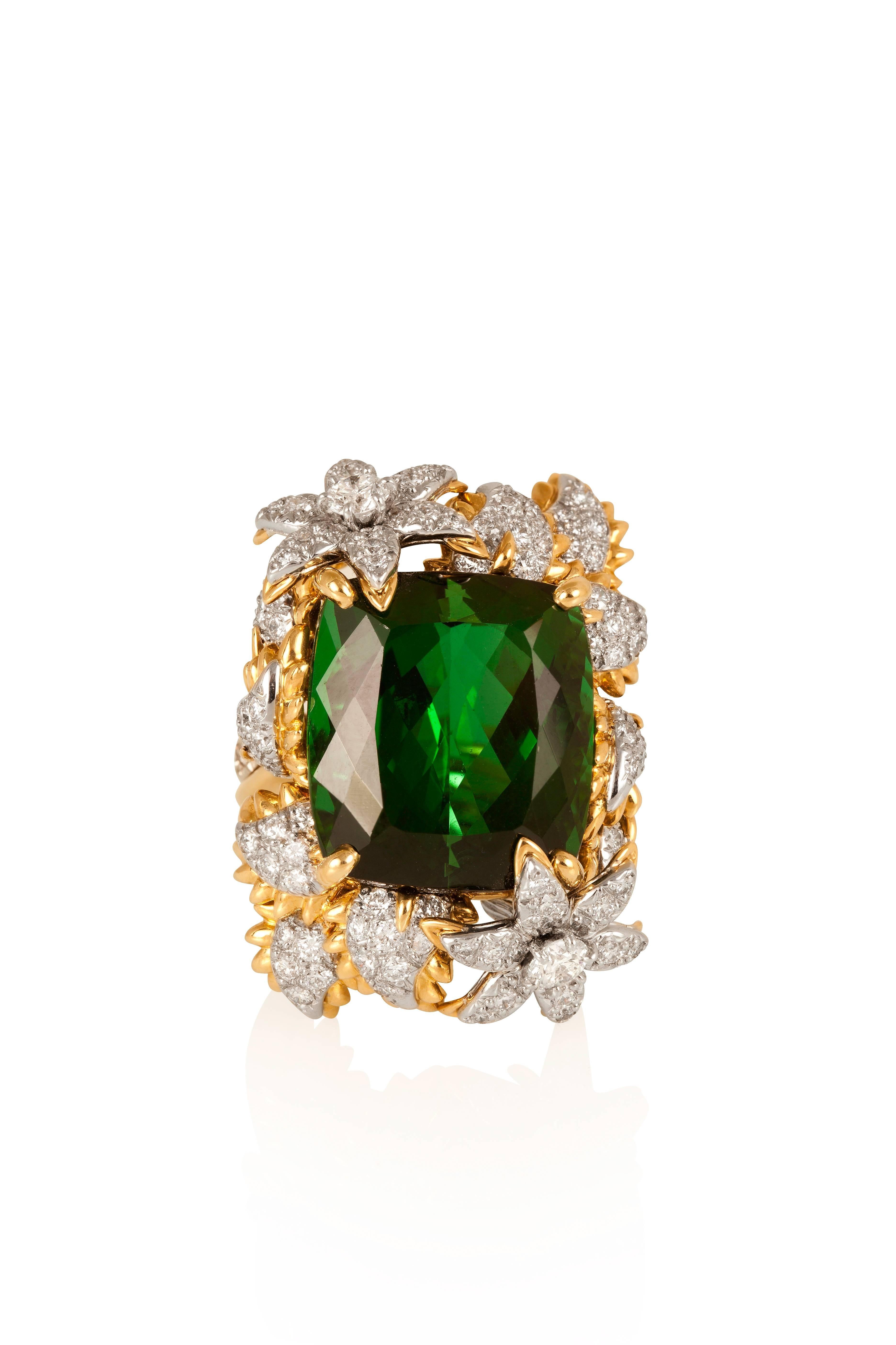 Centered on an exceptional cushion green tourmaline weighing approximately 30 carats, this exuberant ring is decorated with diamond- encrusted flowers and petals, mounted in 18-karat yellow gold and platinum.
Ring size: US 7.5

CREDENTIALS
•