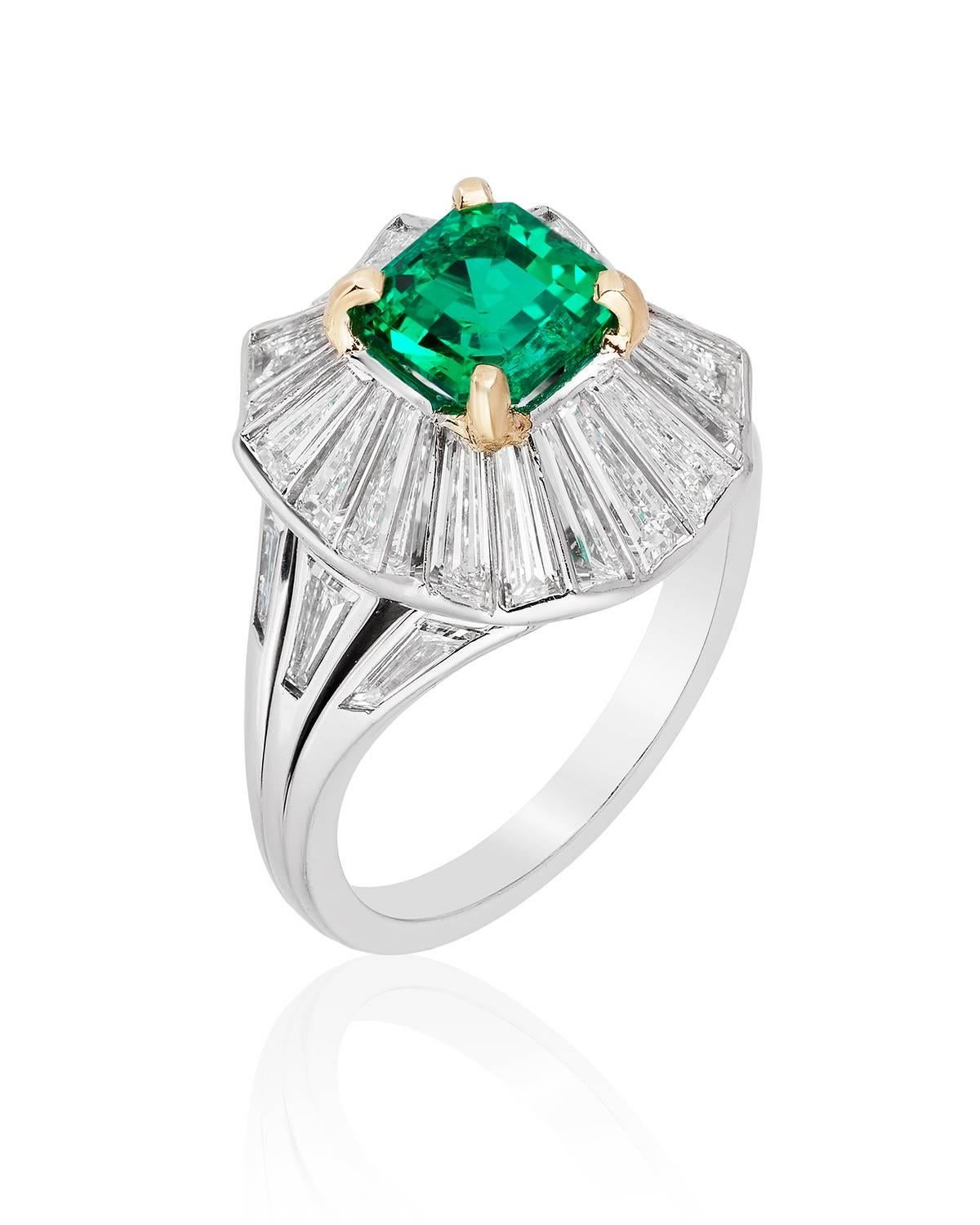 Centered on a beautiful untreated Colombian emerald weighing 1.44 carats, this ring is brought to life by an undulating surround composed of custom cut tapered baguettes.