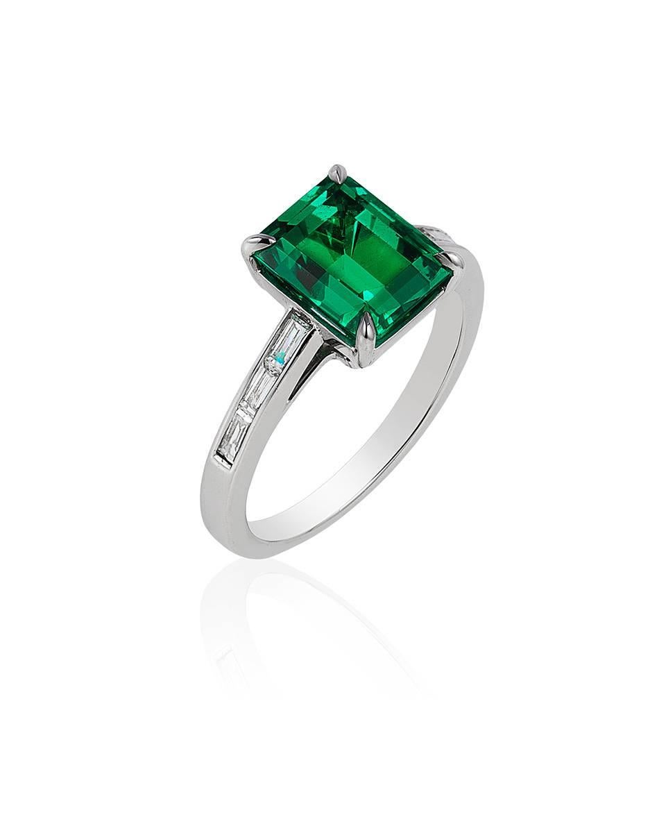 This elegant ring is centered on an emerald cut emerald of exceptional color and clarity weighing 2.58 carats and flanked by six baguette diamonds weighing 0.24 carats, mounted in platinum.

CREDENTIALS
•	AGTA Gemological Testing Center Report