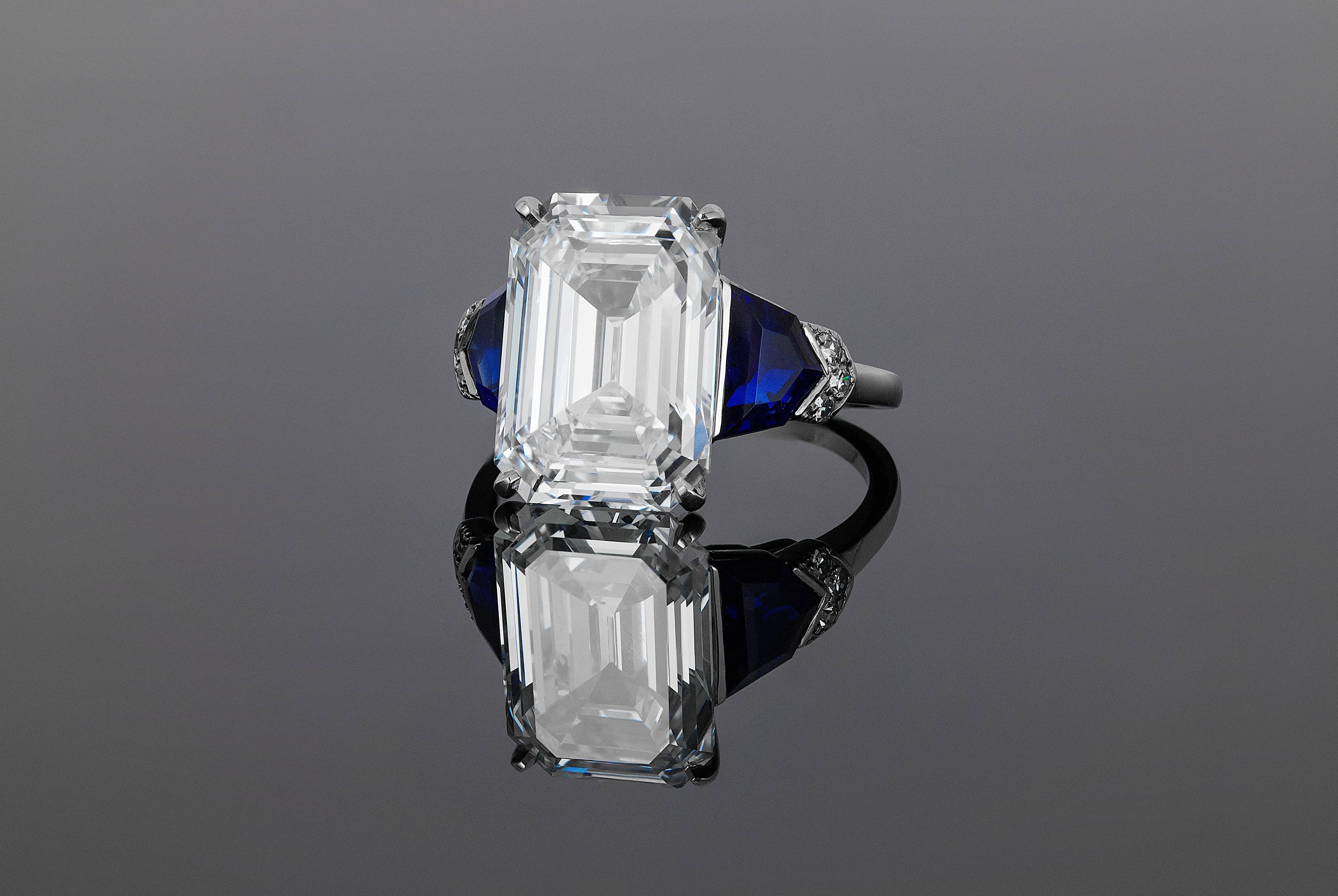 Featuring a beautiful emerald cut diamond weighing 6.23 carats and boasting F color, IF clarity, and classified as Type IIa, this ring by Raymond C. Yard is enhanced with shield shaped sapphires and a trim of diamonds.

COMMENTS
Most famous for