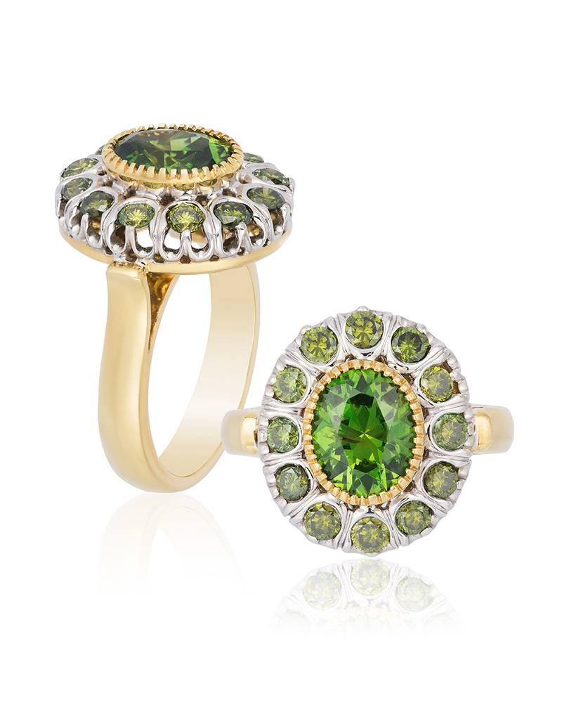 Centered on a superb Russian Demantoid weighing an estimated 2.25 carats, this stylish ring features a halo of another twelve stones, all mounted in 18-karat white and yellow gold.
Ring size: 6 ¾