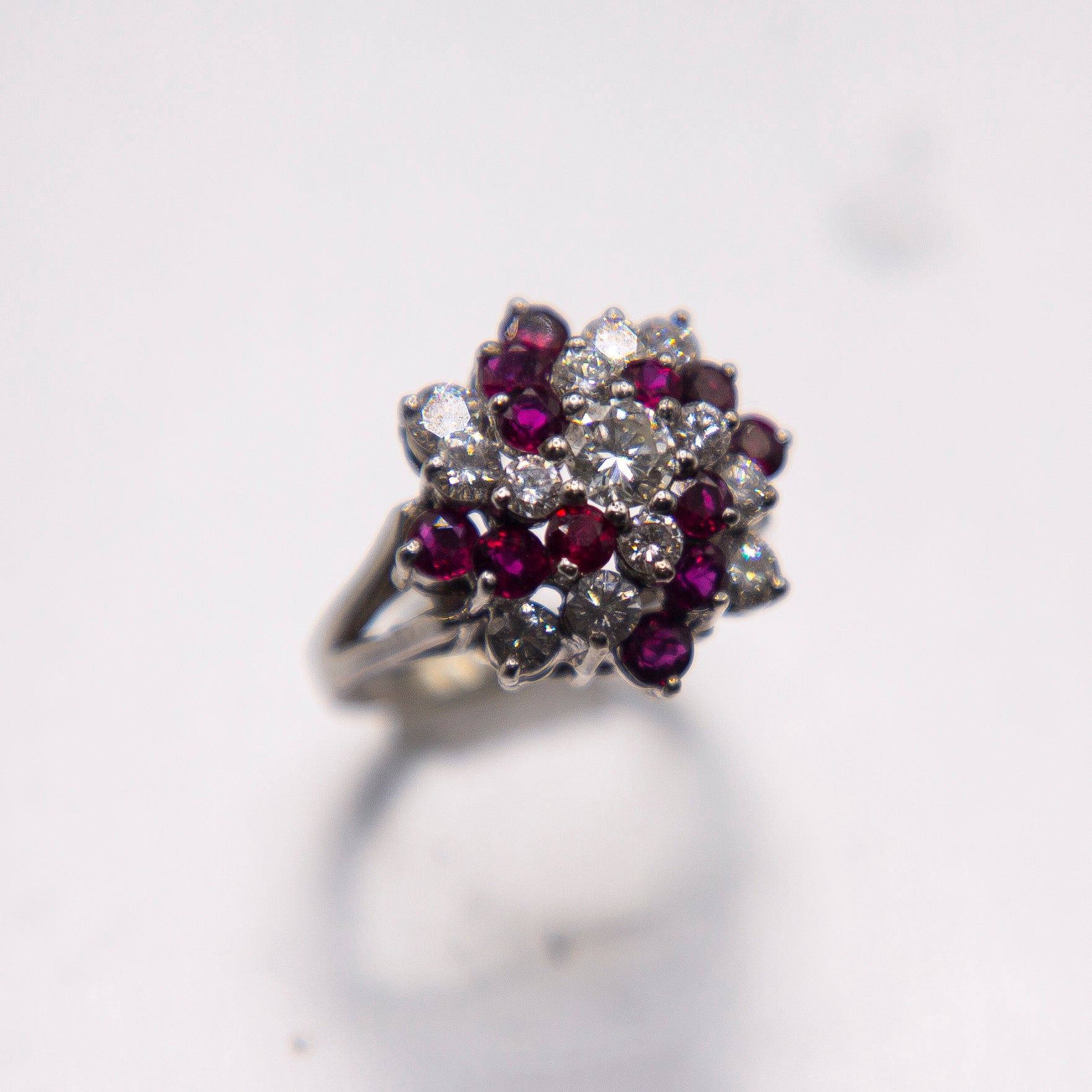 The classic pinwheel style cluster features superbly matched intense ,transparent red marquise rubies weighing 2.50 carats set amongst top collection color fine diamonds. From a Venice FL estate, the ring is in impeccable shape, circa 1970,
