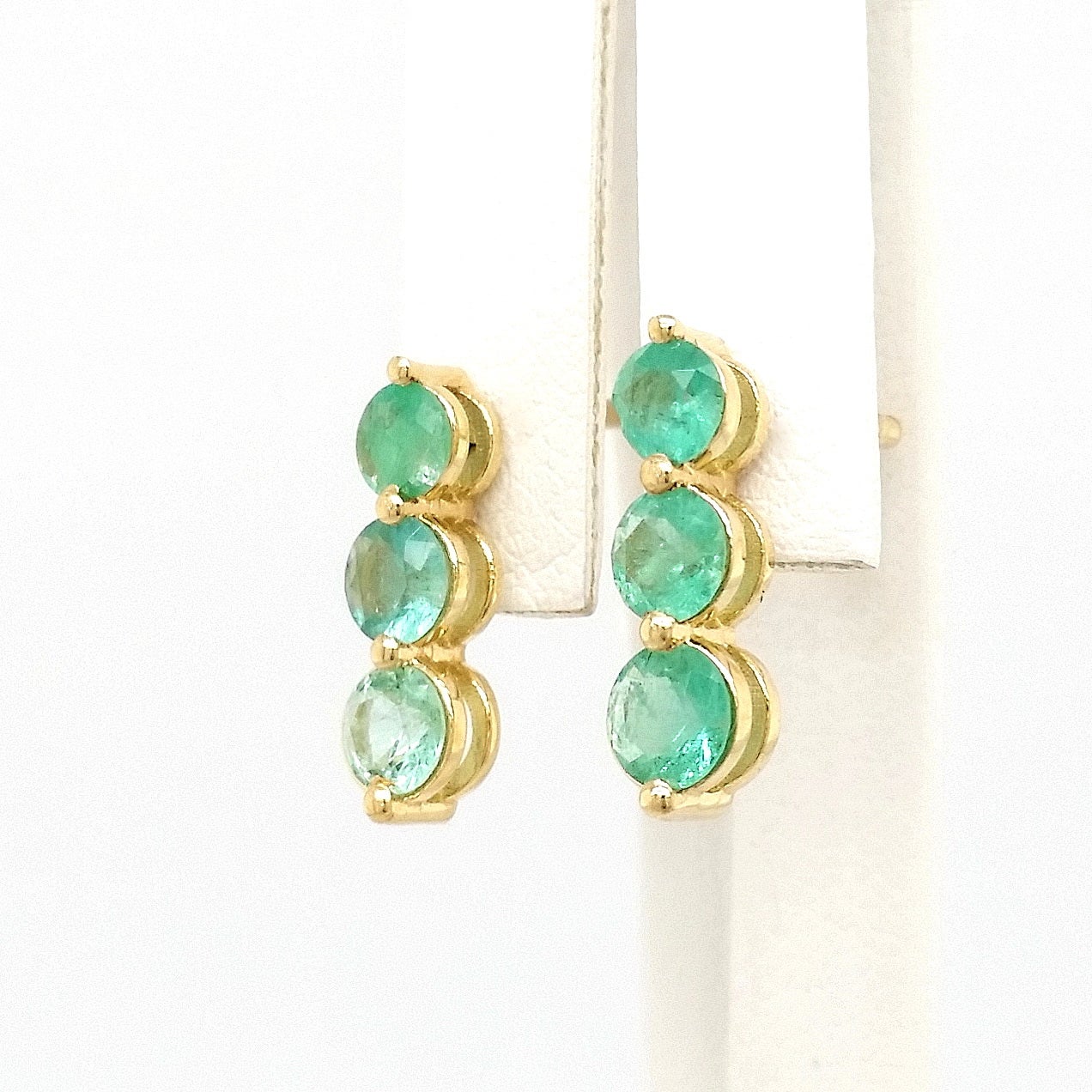 FOR U.S. BUYERS NO VAT 

This elegant earrings feature three Emerald round brilliant sets in 14kt Yellow gold. Each earring is consisting of three emeralds, so this beautiful pair of earrings has a total of six emeralds weighing 1.05 carats in