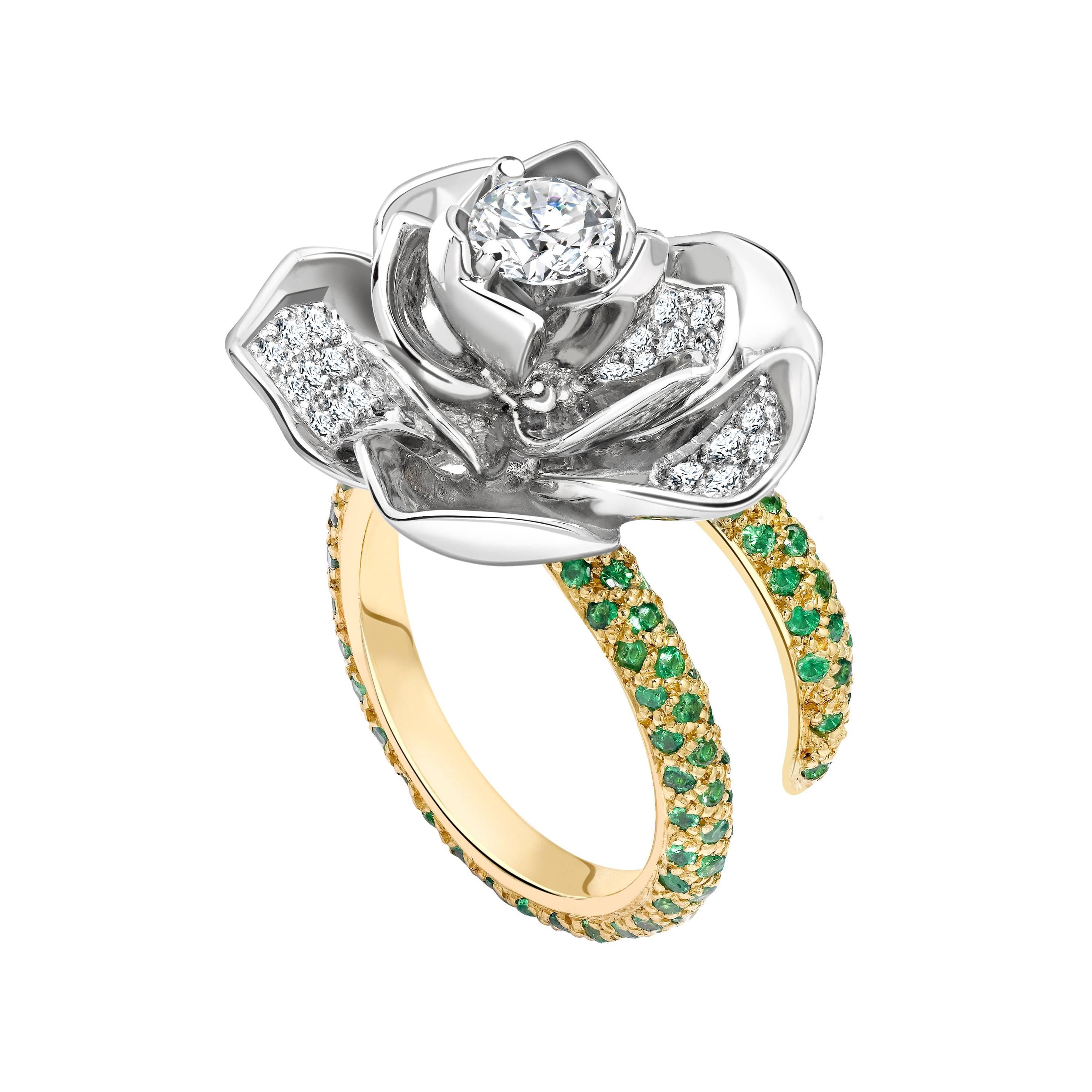 This ring is handcrafted in London from 18ct yellow gold and platinum. The band is pave set with vivid green tsavorites which total 1.30ct. The lotus bud is set with a central Gia certified white diamond which is 0.50ct and is Evs1 quality. The
