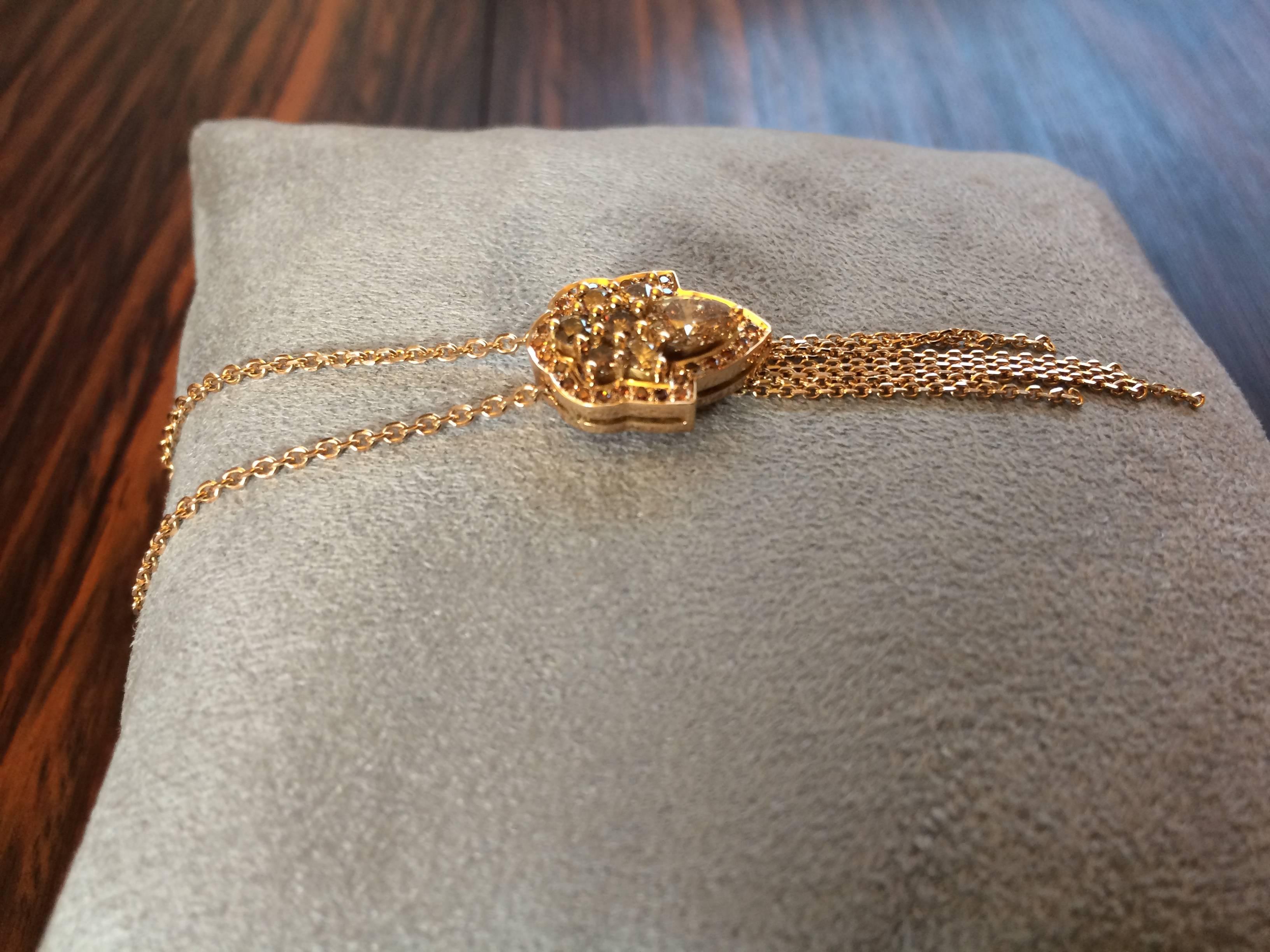 This pendant has been handcrafted from 18ct rose gold and is set with 1.05ct natural cognac diamonds which are Vs clarity. 

The chain is 43cm long or 17 inches but can be altered.
Diameter: 1.4cm
Length at the longest point: 4.2cm

This pendant has