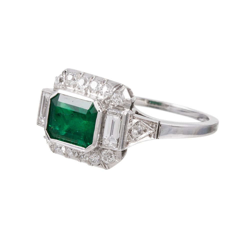 A 1.50 carat emerald set in the “East-to-West” style, and framed with .40 carats of brilliant white diamonds. Crafted in platinum, this original art deco treasure has been preserved in excellent condition. The ring can be resized on request.