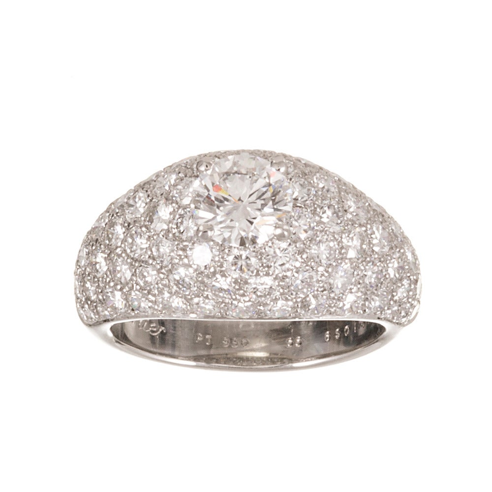 A classic diamond dome ring set with a 1.06 carat round brilliant diamond center, which is nestled among eighty five additional brilliant diamonds that weigh 2.25 carats combined. GIA grades the center diamond F color and Vs1 clarity. The accent