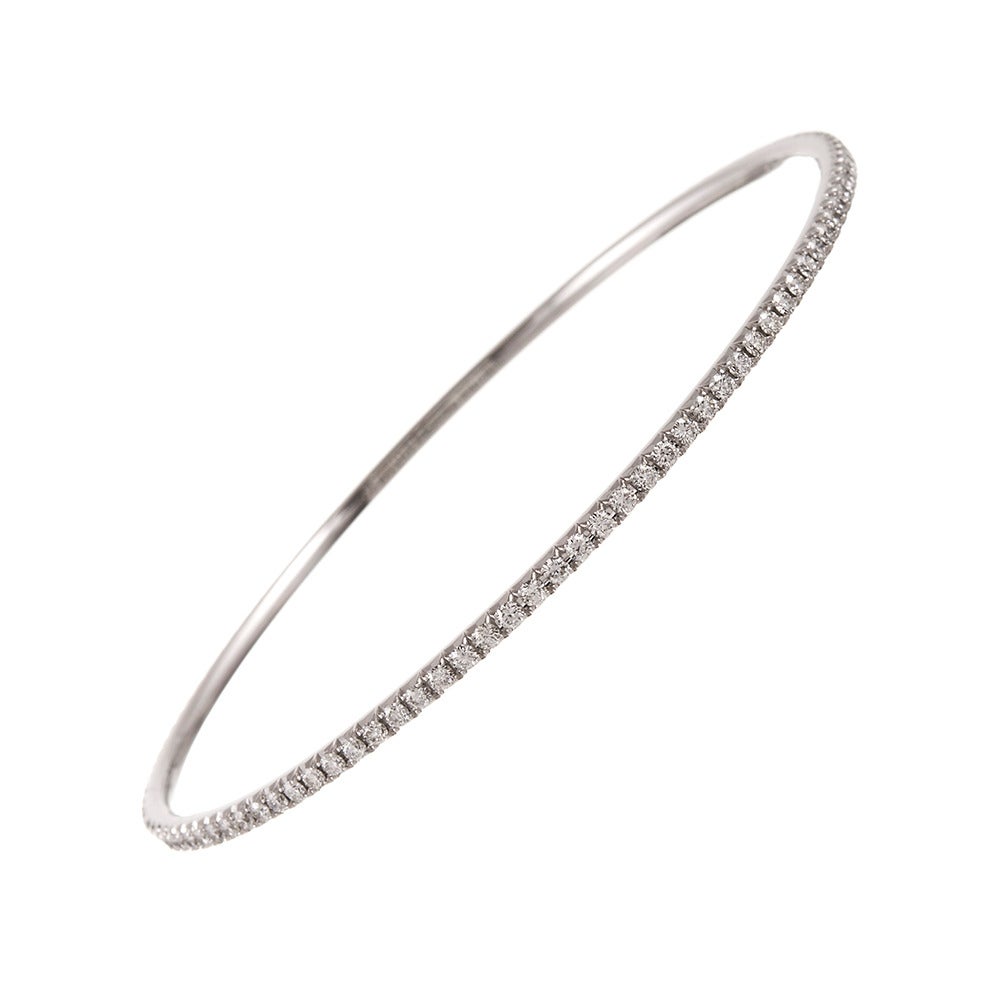 18k white gold bangle bracelet- a perfect circle of 1.75 carats of white diamonds that grade F-G color and Vvs clarity. The bracelet measures 2.5 inches in diameter and is in excellent condition. Signed “Tiffany & Co”.