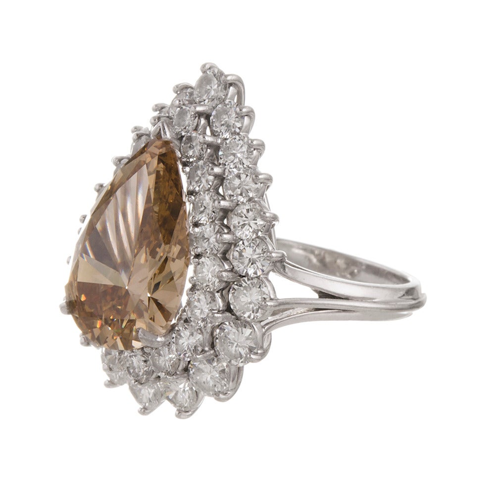 A classic cluster ring in platinum from the 1950s offering a very impressive look that is certain to garner some compliments. The center diamond is GIA-graded “fancy brown-yellow” with Vs2 clarity and weighs 6.13 carats. There is a two-row frame of