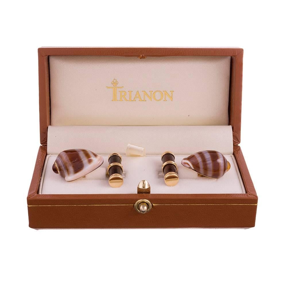 A charming pair of cufflinks, compliments of the esteemed house of Trianon, a division of famed American jeweler Seaman Schepps. These 18k yellow gold cufflinks are made of Cassidula shells and tipped with citrine cabochons. The bars are set with