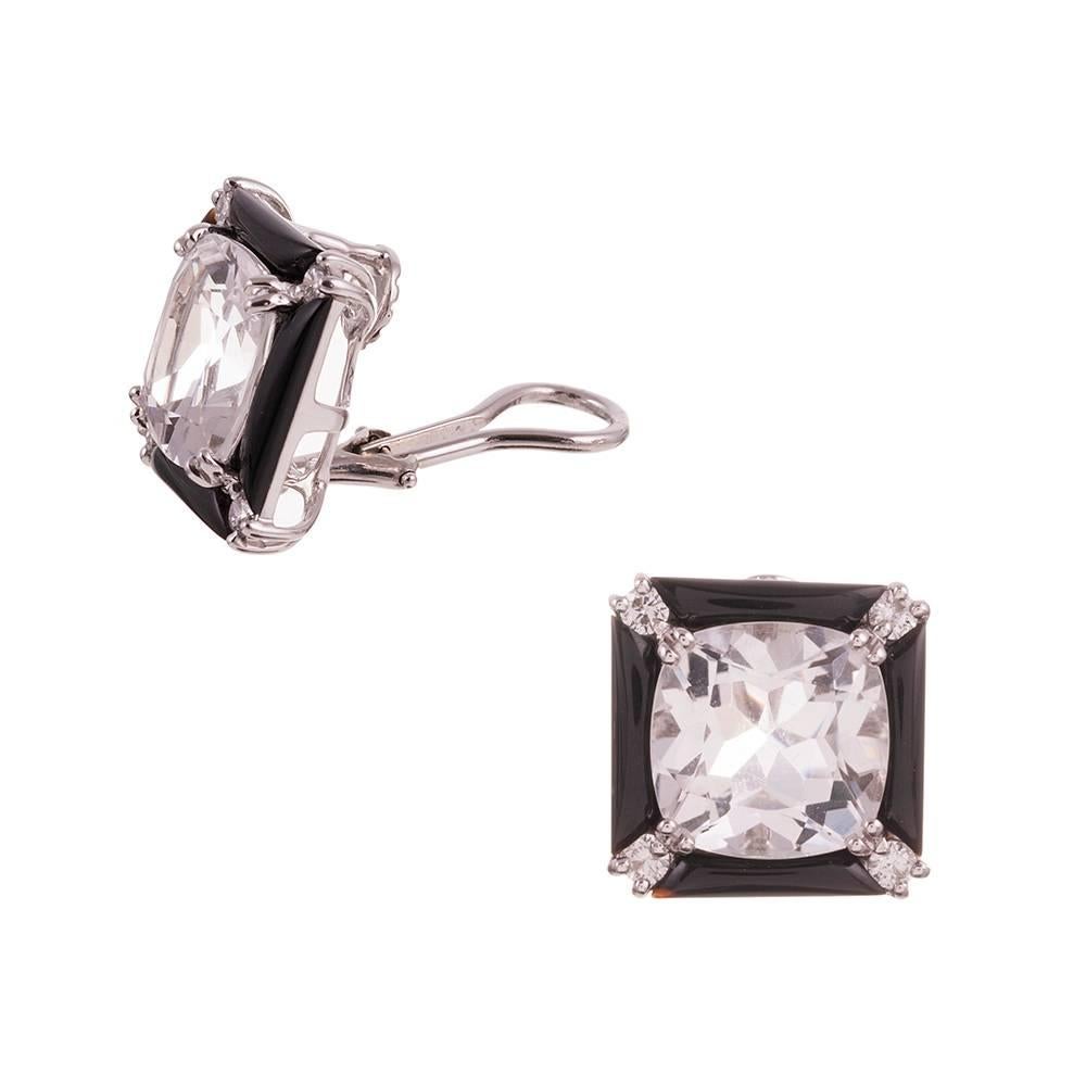 A sophisticated and glamorous design, compliments of iconic American jeweler Seaman Schepps. A large faceted rock crystal anchors a frame of brilliant round white diamonds and onyx bars, all set in 18 karat white gold. 5/8 inch tall and 5/8 inch