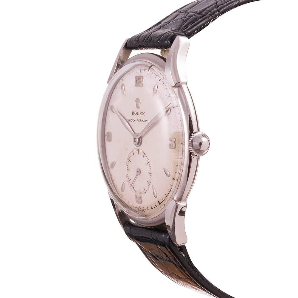 A handsome vintage dress watch- uncommon to find in stainless steel and even more so in an assertive size- offered in beautiful original condition. The case is nice and crisp, with the crown logo and original numbers still visible on the case back,