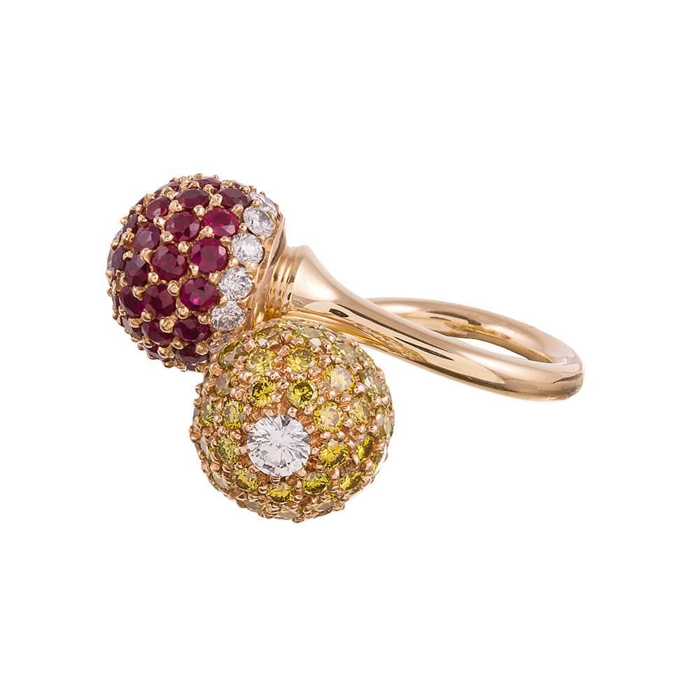 A playful creation with bold style elements and fluid design, wrapping a band of 18k yellow gold around your finger and topping it with gemstone set orbs in rich primary colors. In total, there are 3.60 carats of rubies, 2.68 carats of white