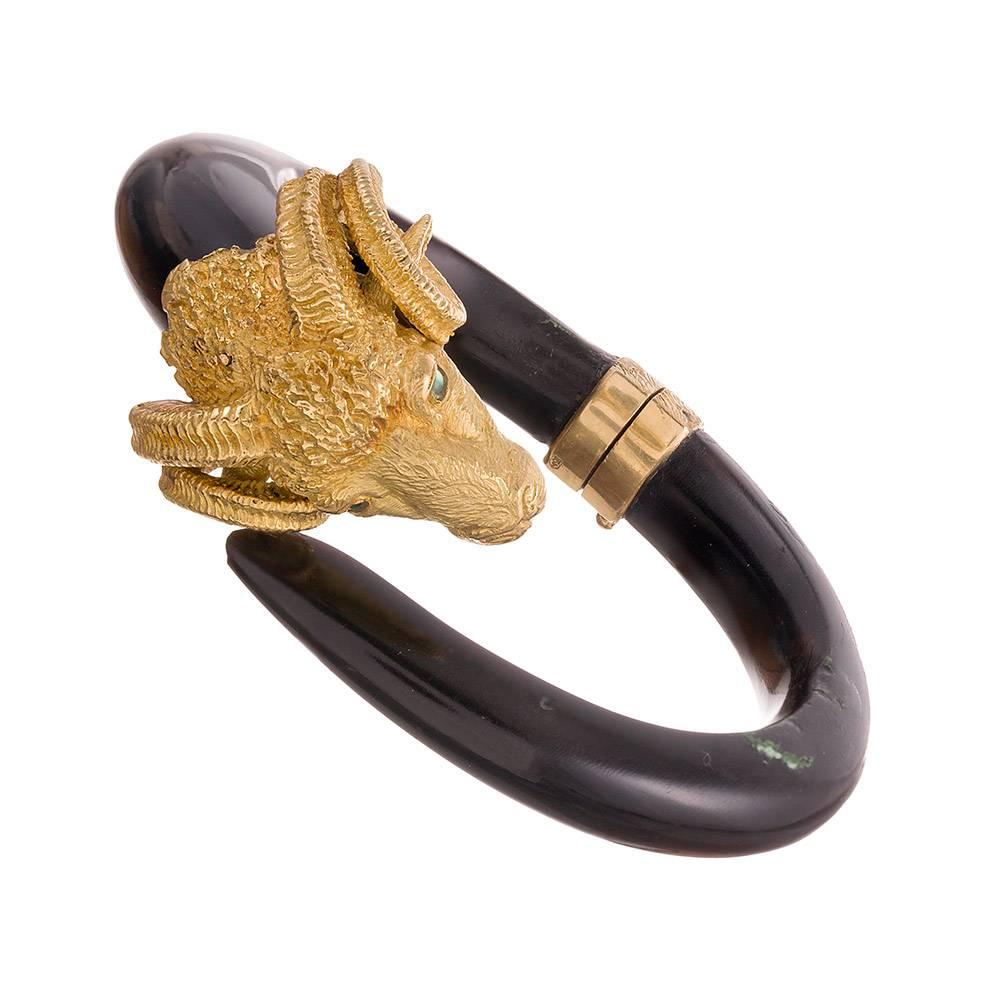 An iconic design rendered in striking detail and with masterful skill, combining carved black bone with heavily hand textured 18 karat yellow gold. The interior diameter of the bracelet measures 2.5 by 2 inches and the piece opens with a single