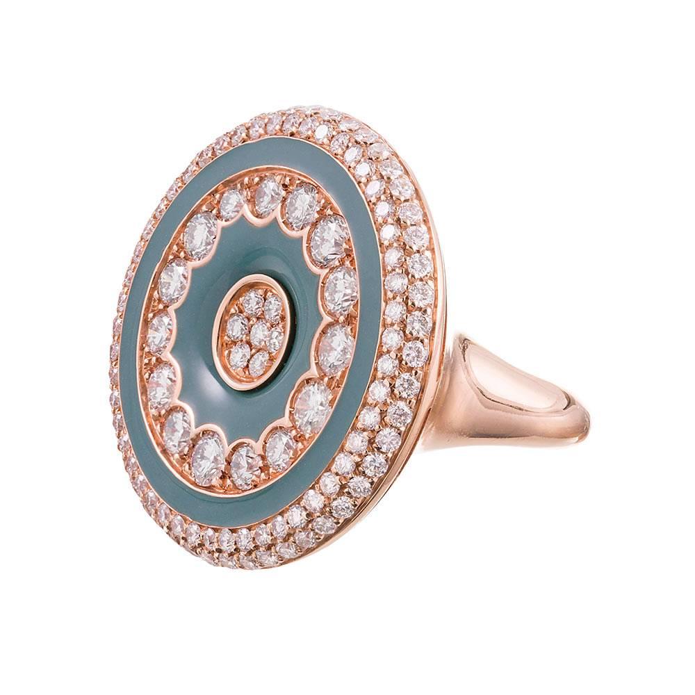 An 18 karat rose gold plaque ring with a round top, decorated with a concentric pattern of diamonds and green onyx. The color combination is unique and symbiotic, creating a piece that is subtly alluring and has a playful, modern feel. In total,