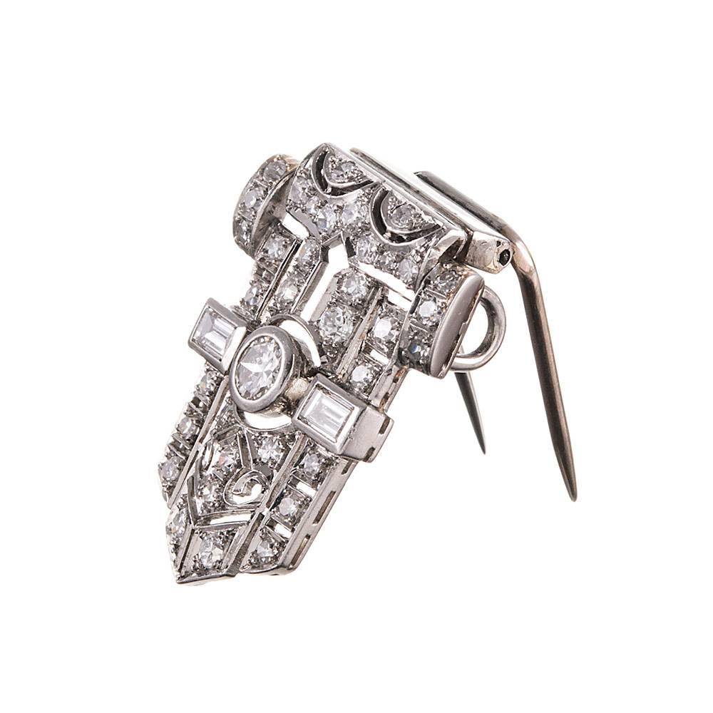 Shaped like the tip of a belt folded through a buckle, this smart looking art deco clip will make a lovely adornment to your favorite lapel. It is also fashioned as an enhancer or pendant, with a double set of loops concealed at the back through