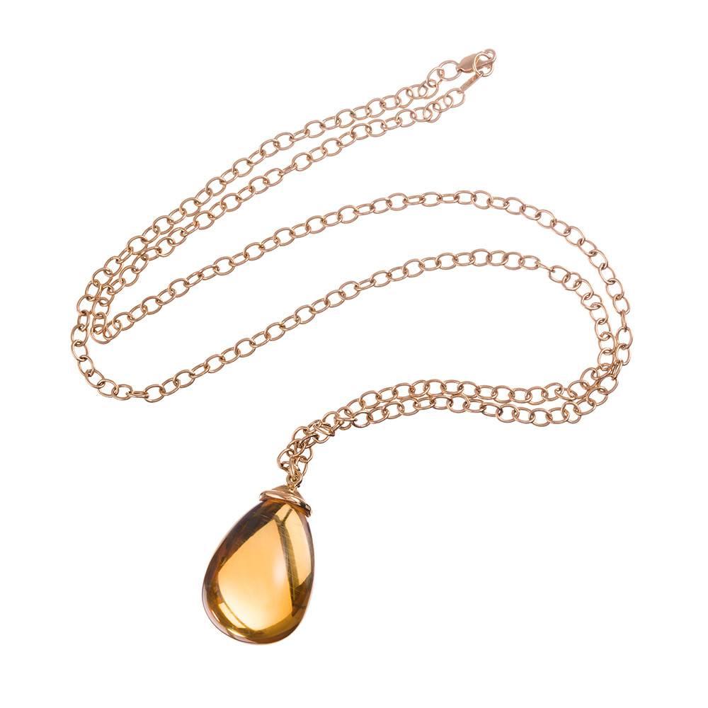 A large orb-like pendant of citrine weighing approximately 100 carats is capped with a golden bale and suspended from a 30 inch chain of nearly round golden links. This is a fun and fashionable piece of fine jewelry offered in a color that is