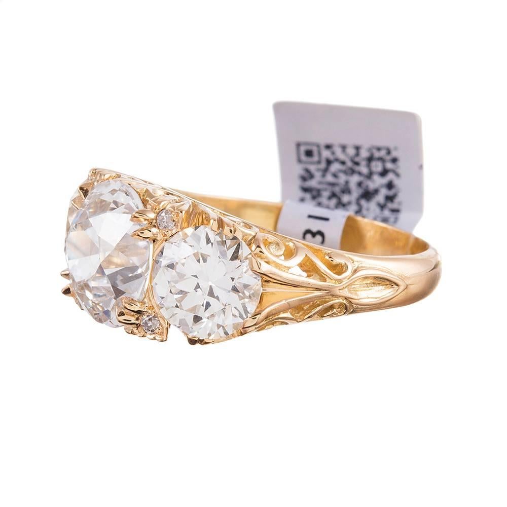 A modern conception of a classic Victorian design, pairing three major round diamonds in an English carved style 18k yellow gold mounting in masterful splendor. This setting style is gorgeous from all angles and looks very impressive on the finger,