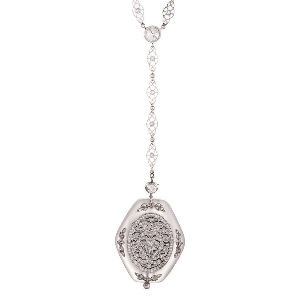 An incredible art deco treasure, designed as a hexagonal rock crystal pendant, extensively decorated with diamonds filigree and suspended from an ornate platinum diamond-set chain. Wear the necklace with the gorgeous diamond portrait facing the
