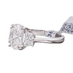 2.05 Carat Oval Brilliant Plus Trapezoid Diamond Platinum Three Stone Ring