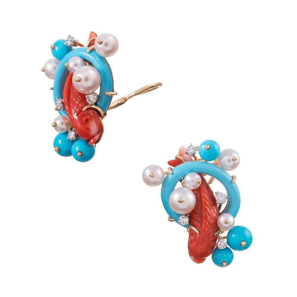 A charming design, compliments of iconic American jeweler Seaman Schepps. Hand carved red coral koi sit nestled in a basket of sweeping strokes of turquoise “waves” , pearl “sea spray bubbles