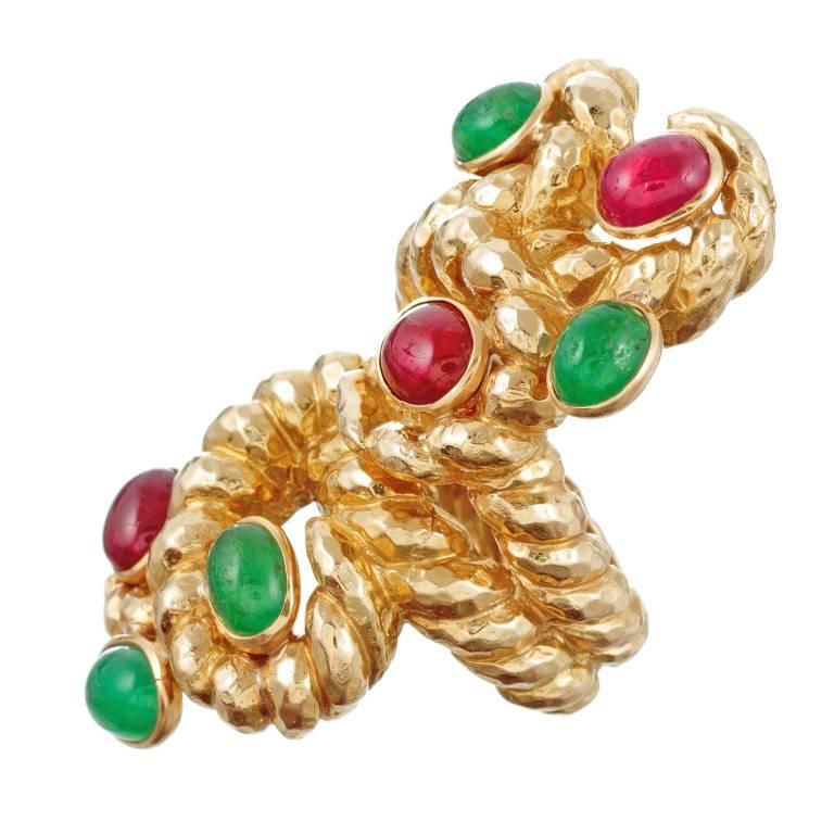 David Webb Ruby and Emerald Yellow Gold Ring. Cabochon rubies and emeralds grace this unusual 18 karat yellow gold intertwined rope design ring. This ring measures a heart stopping 2 inches long by one inch across ! What a statement!