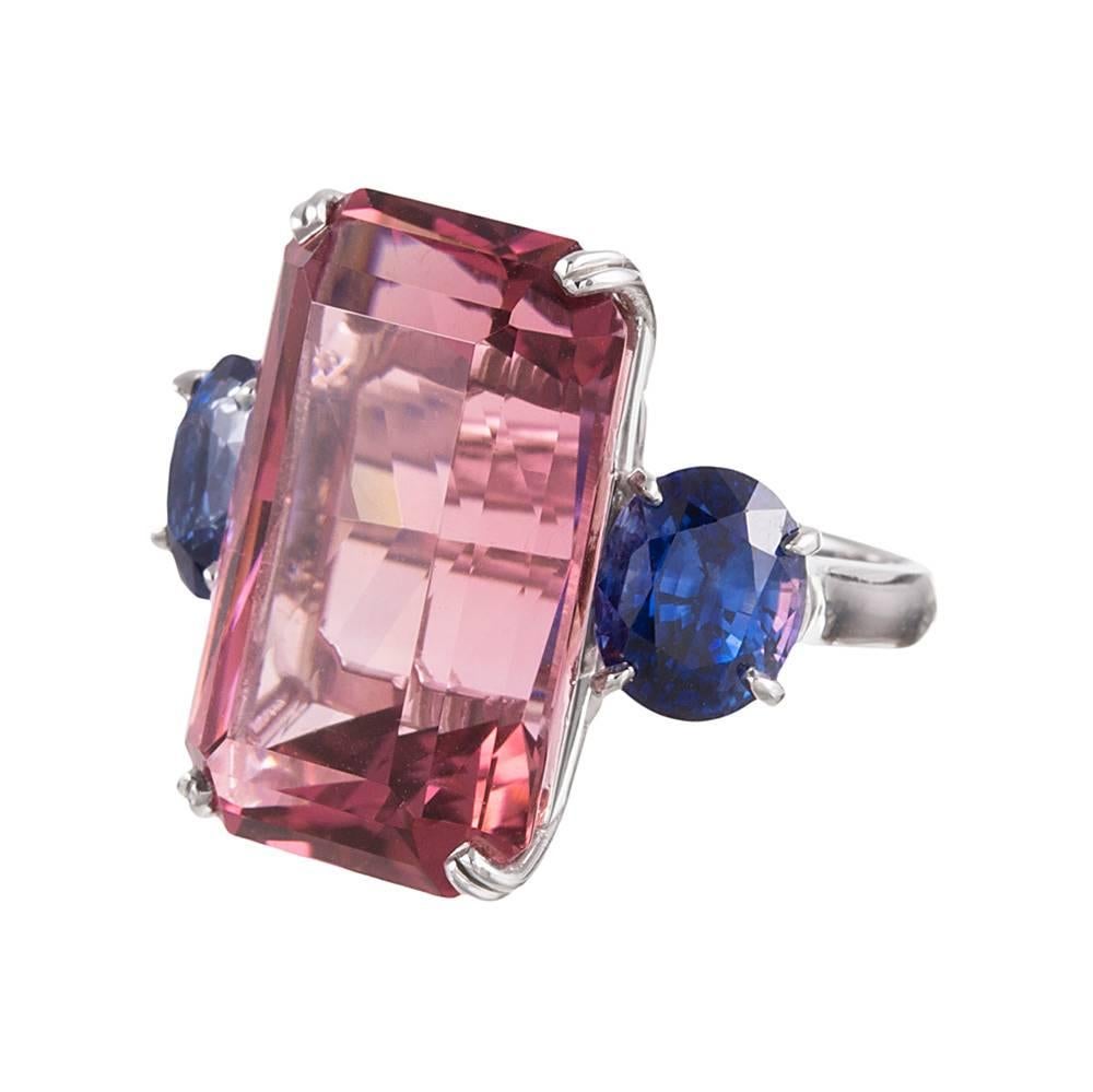 A unique combination of gemstones assembled in a classic three stone design, the absence of diamonds heightening the modernity and celebrating colored gemstones for the sake of their individual beauty. The center pink tourmaline exhibits a subtle