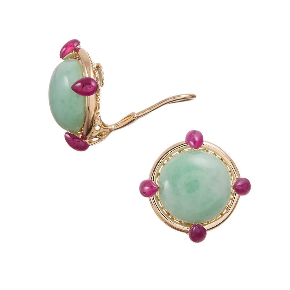 A stunning combination of cabochon jadeite with rubies set at the compass points, compliments of American jewelry icon Seaman Schepps. 3/4 of an inch in diameter. Mounted in 18k yellow gold and currently clips, however a post can be added on request.