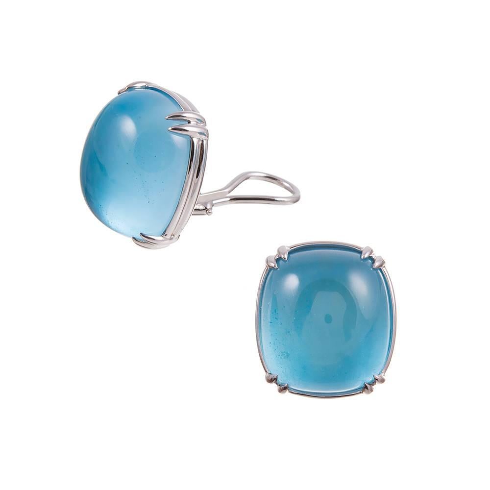 Large cabochons of blue topaz set in 18 karat white gold, compliments of iconic jewelry designer Seaman Schepps. A beautiful opaque blue but being pleochroic, topaz can display different colors in different crystal directions. Currently clips,