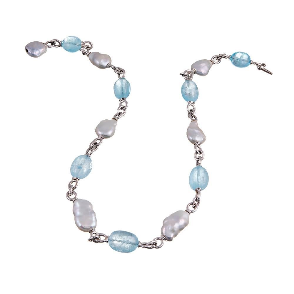 Large beads of blue topaz are complimented by freshwater baroque pearls and set in 18 karat white gold, compliments of iconic jewelry designer Seaman Schepps. A beautiful sky blue but being pleochroic, topaz can display different colors in different