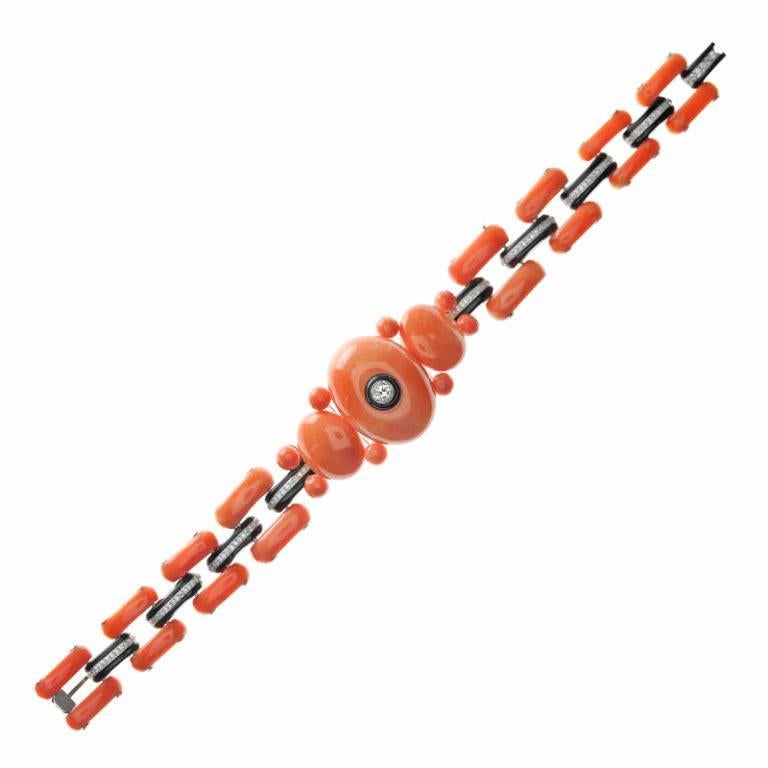 A unique and all-original Art Deco diamond, coral and onyx bracelet. Handmade in platinum, the design of this bracelet is very Art Deco although unlike anything we've seen. The bracelet is made in incredible fashion, extremely stylish by today's