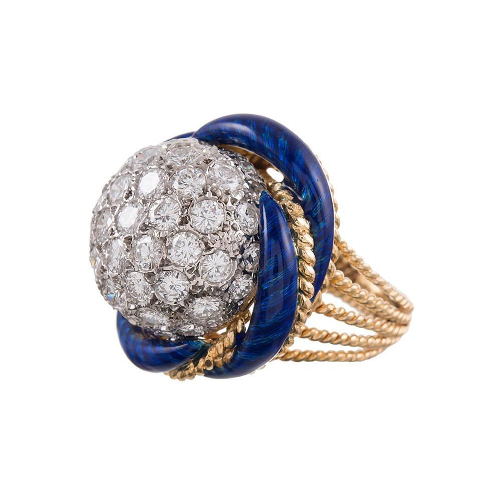 18k yellow gold dome ring designed as a knot of rich blue enamel and twisted golden rope with a dome of diamonds nestled at the center. Five rows of gold taper to form the shank. Classic 1960s jewelry at its finest! Size 5.25 can be resized on