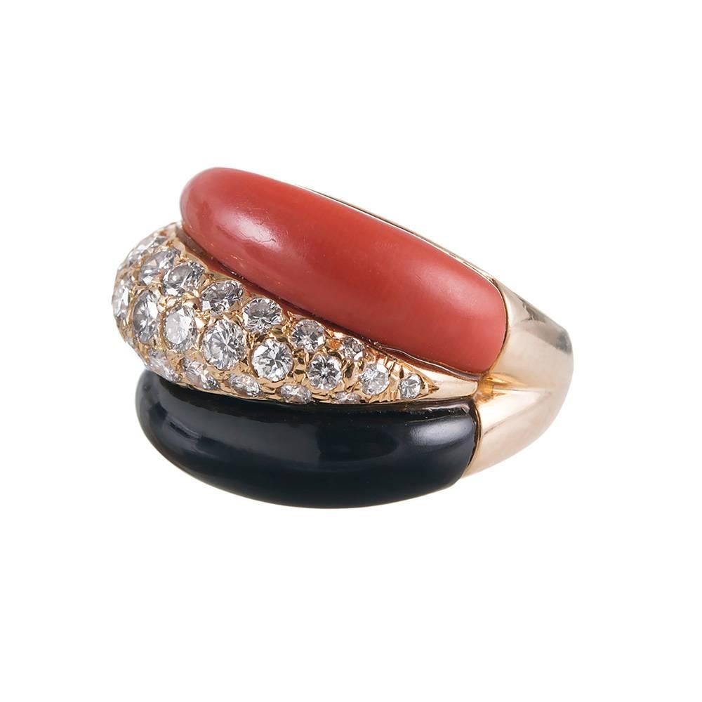 Substance and luxury define this sophisticated creation that embodies
subtle finery. An asymmetrical section of brilliant diamonds, 1 carat in total and grading as F color and Vvs1 clarity, are flanked by a smooth section of coral and one of onyx,