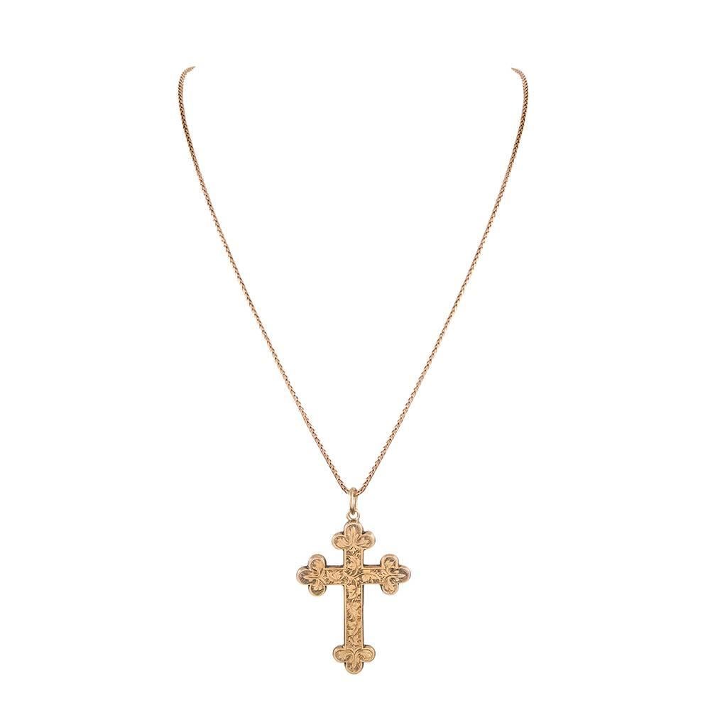 A testament to the artisan that used this golden cross as his canvas, this pendant measures 2.25 by 1.25 inches and every bit of it has been meticulously decorated with skilled hand engraving, with a different pattern displayed on each side. Offered