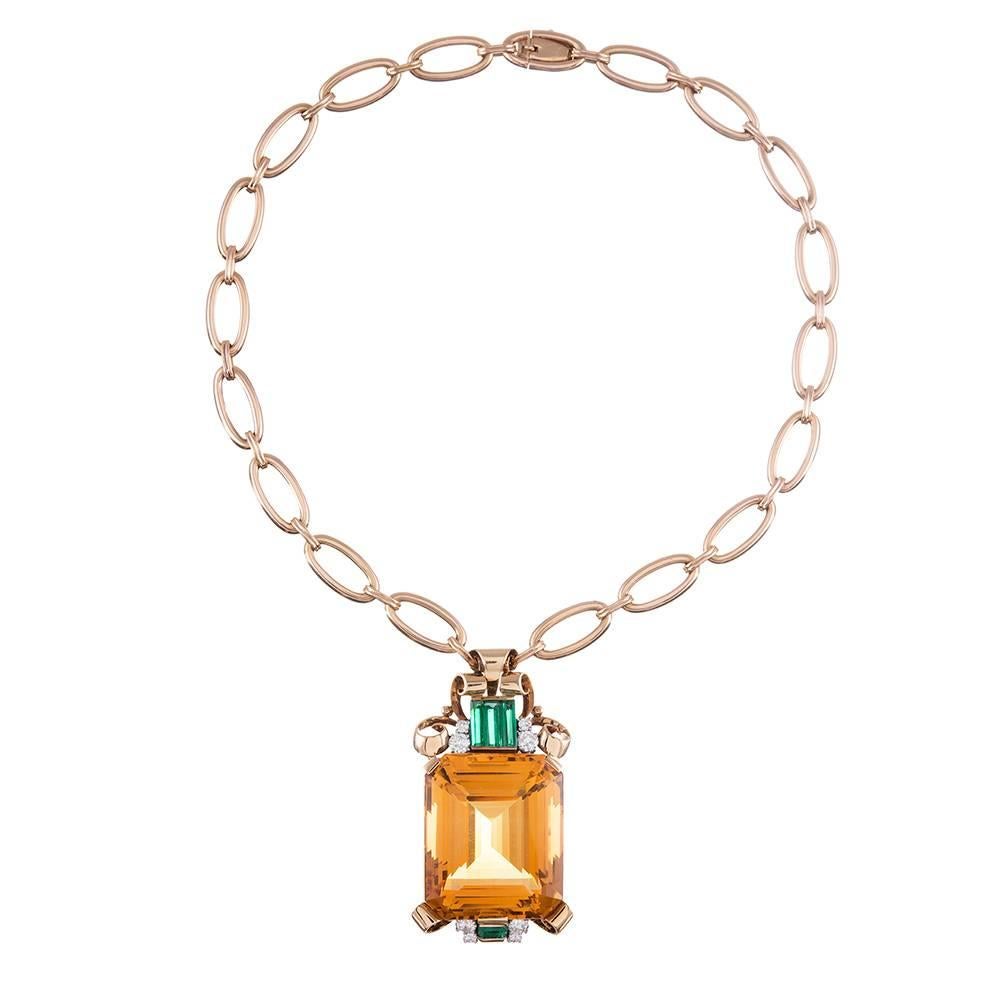 A lovely example of high jewelry from the retro era, this classically styled 1940s piece embodies the bold, yet feminine, aesthetic that retro jewelry collectors so love. Anchored in the center by an approximately 100 carat citrine and accented with