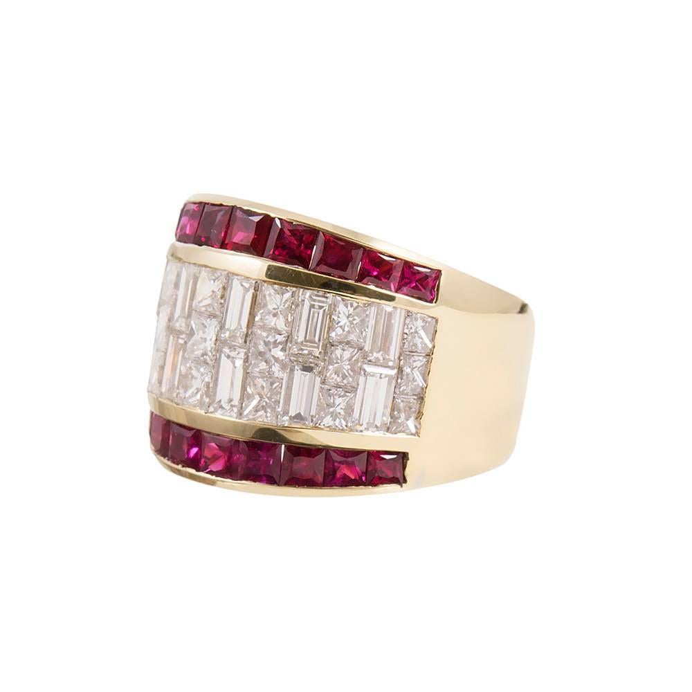 An impressive ring with a comfortable low profile, made of 18k karat yellow gold. The center is a mosaic pattern of princess cut- and baguette white diamonds that weigh 1.90 and 1.85 carats in total respectively. The diamond center feature is