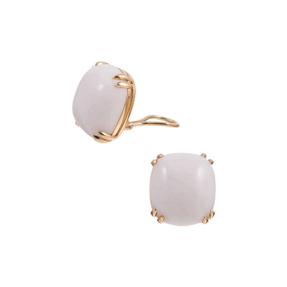 Mounted in 18 karat yellow gold and set with a cabochon of white jade. Currently clips, a post can be added on request for those with pierced ears. These earrings measure approximately 3/4 inch square. 