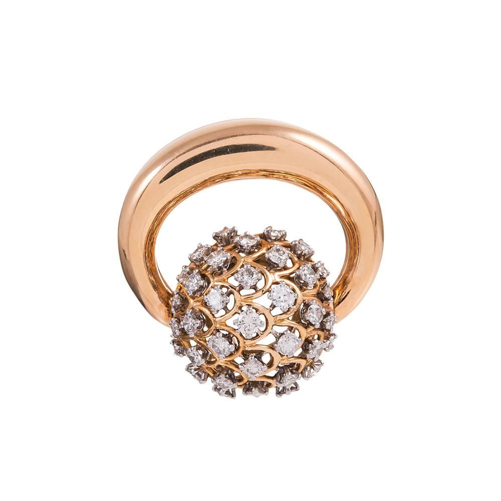 A lovely mid-century adornment for your lapel, this high polished golden knot is anchored in the center by a dome of diamonds that weigh 1.95 carats in total. 2 inches by 1 3/8 inches and rising a full inch high, this unique piece is quite versatile