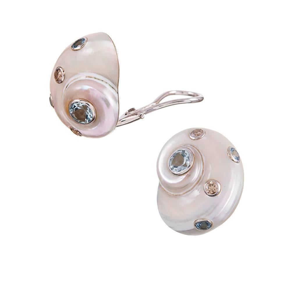 A lovely pair of earrings, compliments of the esteemed house of Trianon, a division of famed American jeweler Seaman Schepps. These 18k white gold mountings display a umbonium shell decorated with bezel set faceted chocolate diamonds (.26 carats)