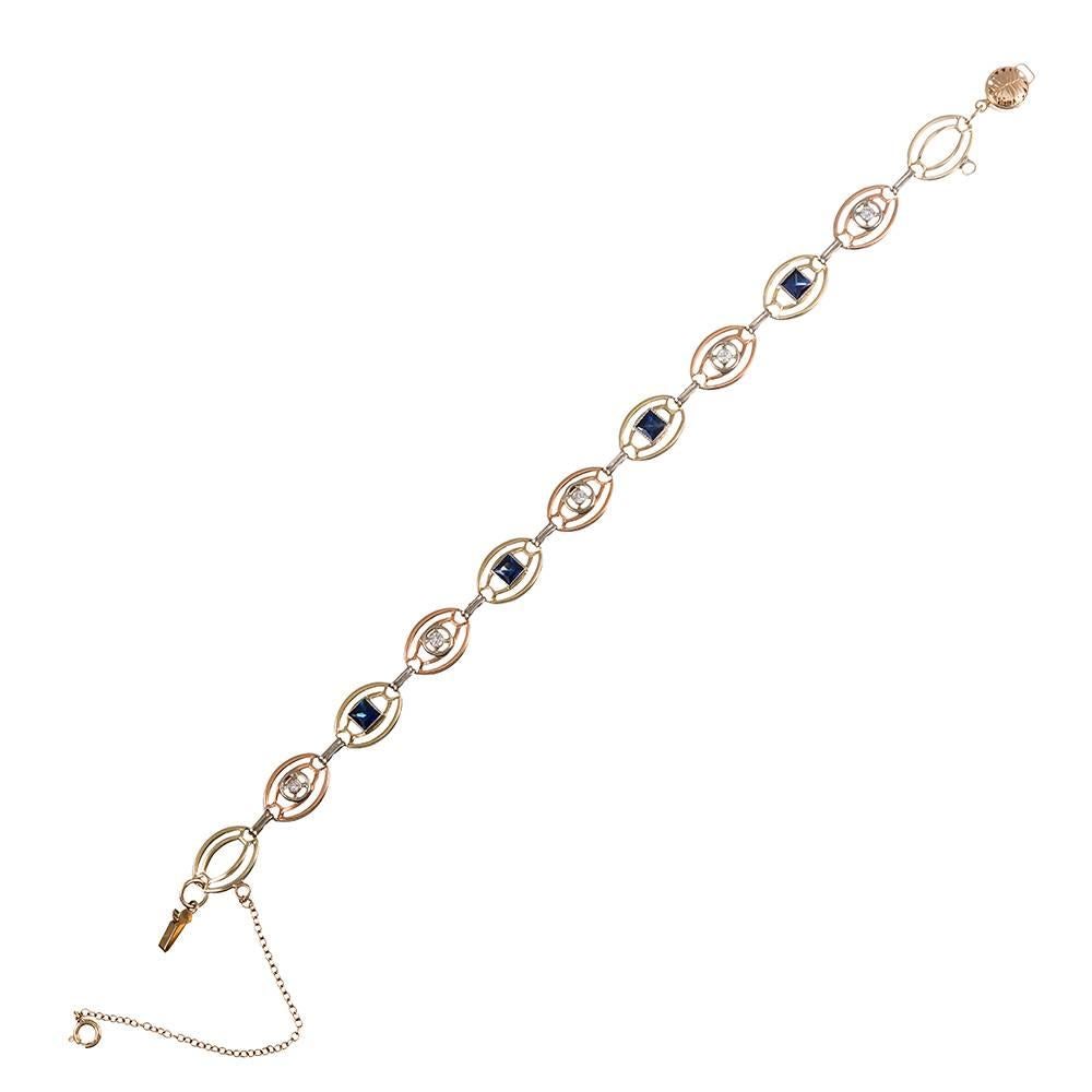 Made of 14k yellow, rose and white gold and decorated with square cut sapphires and round diamonds, this charming bracelet is an artful creation hand made nearly a century ago. Measuring 7.5 inches long and fitted with a safety chain, each link is a