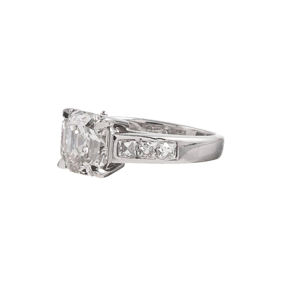 Contemporary styled diamond solitaire, with a 3.16 carat asscher diamond center and complimented by three diamonds on each shoulder. The accent stones weigh .60 carats in total. This ring is accompanied by an IGI appraisal report that describes the